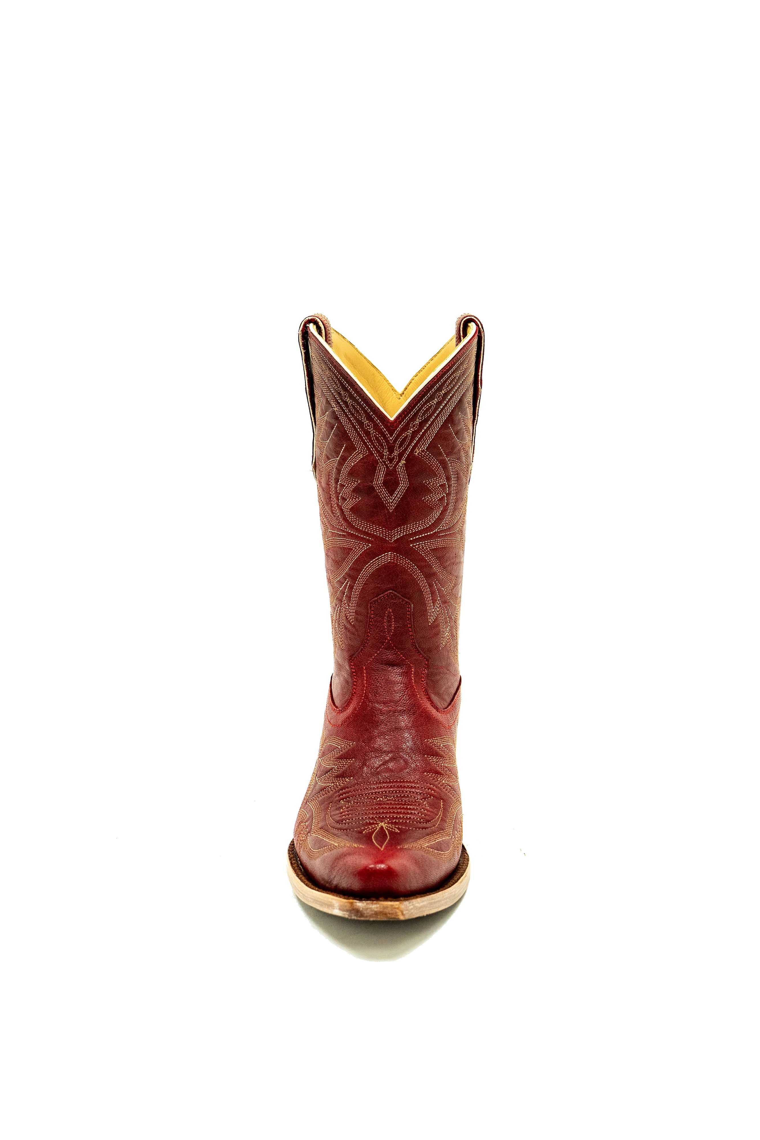 Front of red cowboy boot with white intricate designs on a white background